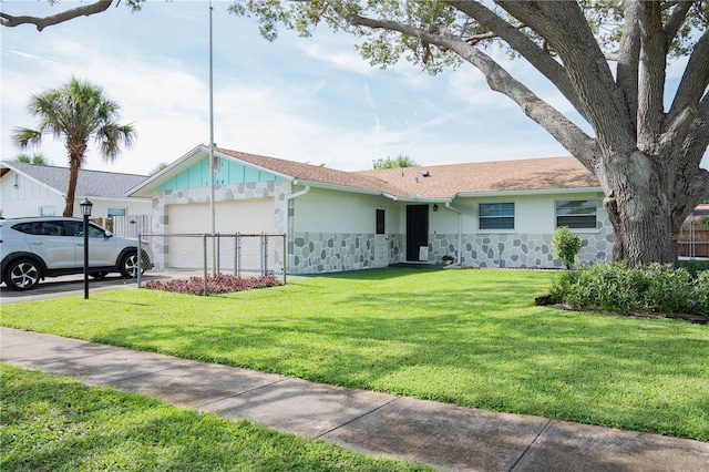 1004 65th Ave W, Bradenton, FL 34207 - ranch-style house with stone siding, an attached garage, a front yard, stucco siding, and driveway