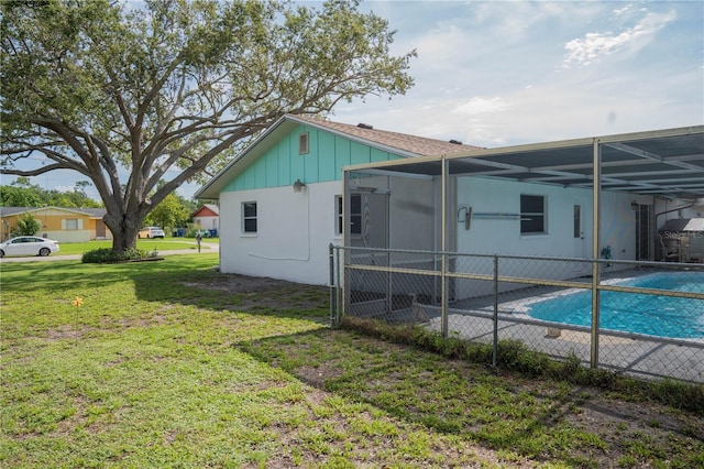 1004 65th Ave W, Bradenton, FL 34207 - rear view of property with a lanai, an attached carport, and board and batten siding