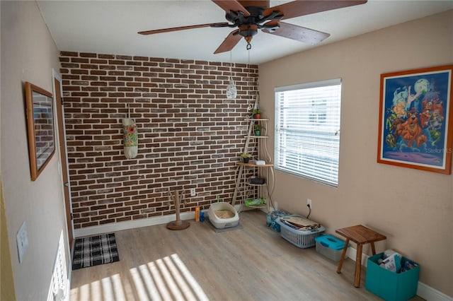 1004 65th Ave W, Bradenton, FL 34207 - spare room with a ceiling fan, brick wall, and wood finished floors