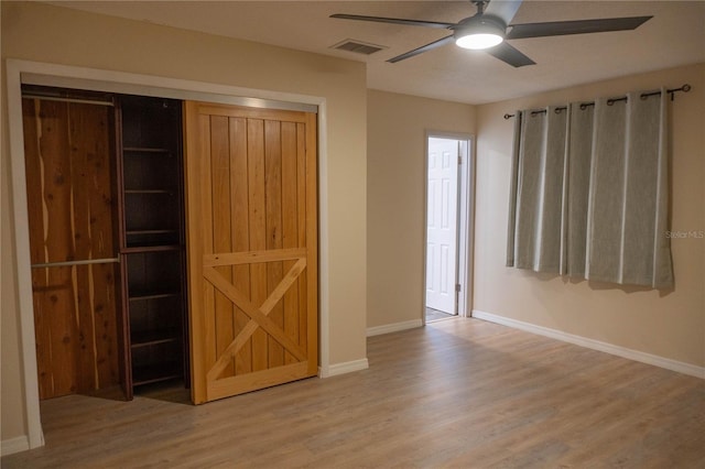 1004 65th Ave W, Bradenton, FL 34207 - unfurnished bedroom featuring wood finished floors, a closet, and a ceiling fan