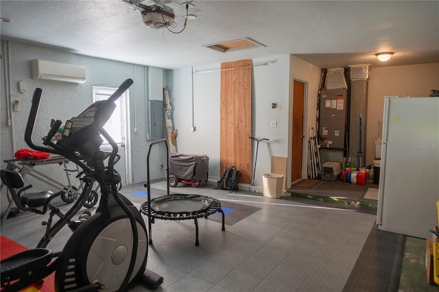 1004 65th Ave W, Bradenton, FL 34207 - workout room featuring a wall unit AC, electric panel, attic access, and heating unit