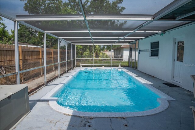 1004 65th Ave W, Bradenton, FL 34207 - view of swimming pool with a fenced backyard, glass enclosure, and a patio area