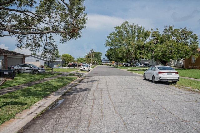 1004 65th Ave W, Bradenton, FL 34207 - view of asphalt street featuring a residential view, curbs, and sidewalks