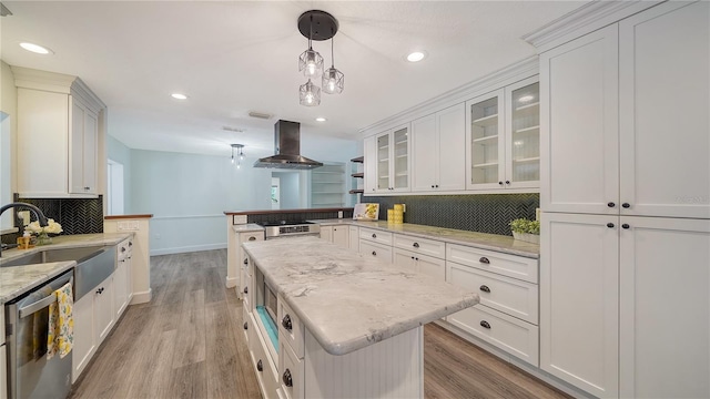 6990 Richardson Rd, Sarasota, FL 34240 - kitchen featuring island range hood, stainless steel dishwasher, a sink, light wood-style floors, and a peninsula
