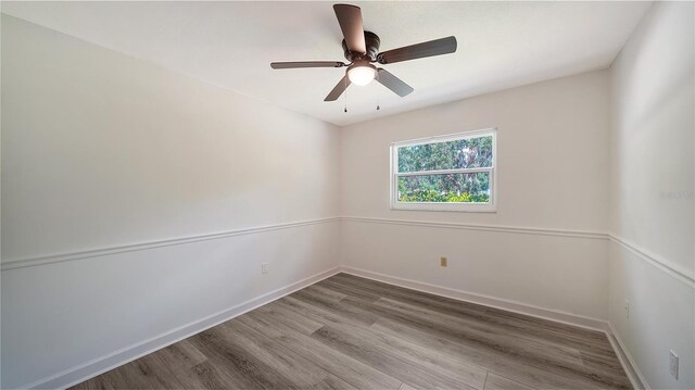 6990 Richardson Rd, Sarasota, FL 34240 - empty room featuring wood finished floors, baseboards, and ceiling fan