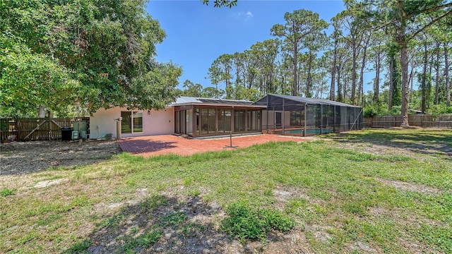 6990 Richardson Rd, Sarasota, FL 34240 - back of property featuring stucco siding, glass enclosure, and a patio area