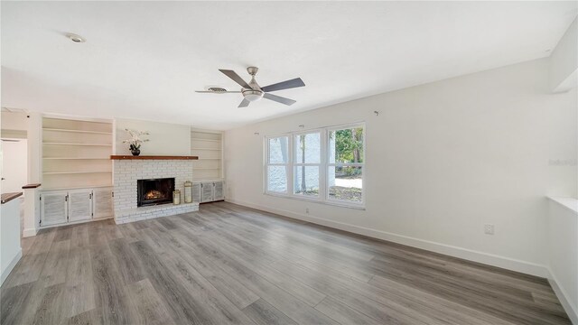 6990 Richardson Rd, Sarasota, FL 34240 - unfurnished living room with baseboards, a ceiling fan, and wood finished floors