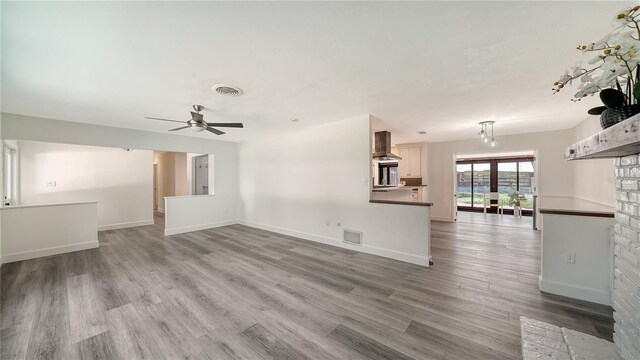6990 Richardson Rd, Sarasota, FL 34240 - unfurnished living room with ceiling fan, wood finished floors, and baseboards