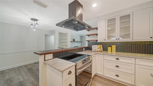 6990 Richardson Rd, Sarasota, FL 34240 - kitchen with island exhaust hood, stainless steel range with electric cooktop, a peninsula, tasteful backsplash, and recessed lighting