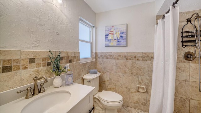 6990 Richardson Rd, Sarasota, FL 34240 - bathroom featuring tile walls, toilet, a tile shower, and vanity