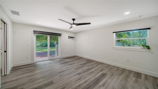 6990 Richardson Rd, Sarasota, FL 34240 - unfurnished room featuring plenty of natural light, a ceiling fan, recessed lighting, and wood finished floors