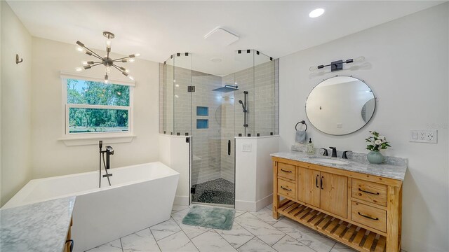 6990 Richardson Rd, Sarasota, FL 34240 - bathroom featuring a chandelier, a freestanding tub, a stall shower, vanity, and marble look tiles