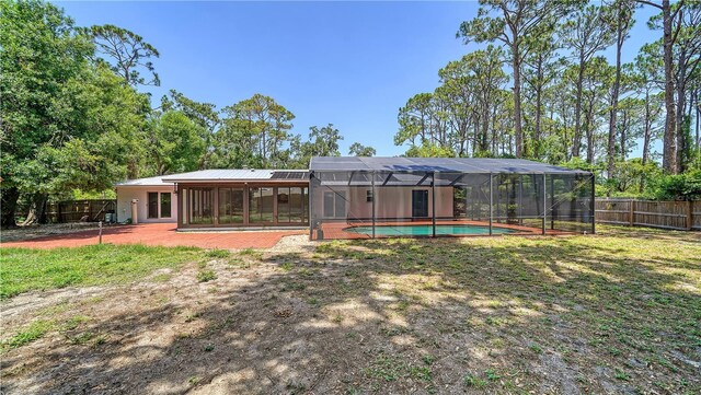 6990 Richardson Rd, Sarasota, FL 34240 - rear view of house featuring a fenced backyard and glass enclosure