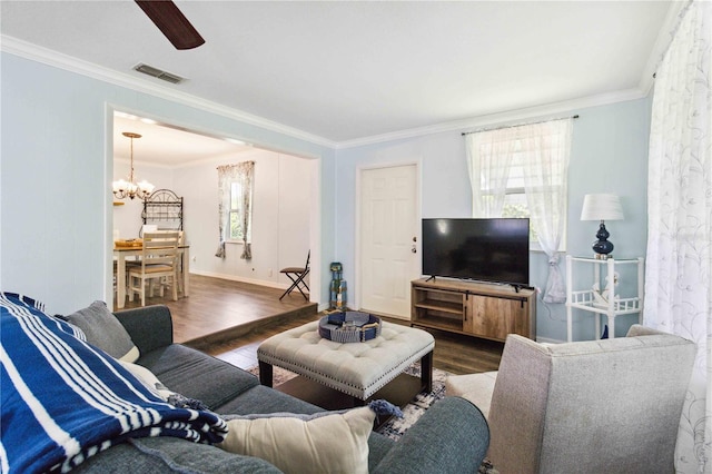 3102 SE 34th Ave, Okeechobee, FL 34974 - living area with a chandelier, wood finished floors, crown molding, a ceiling fan, and baseboards
