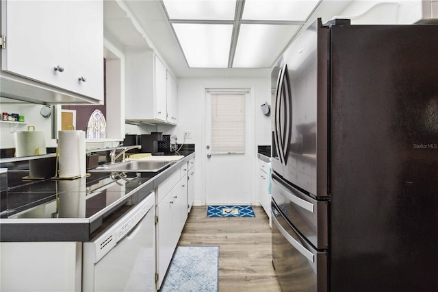 3102 SE 34th Ave, Okeechobee, FL 34974 - kitchen featuring freestanding refrigerator, white dishwasher, a sink, and white cabinetry