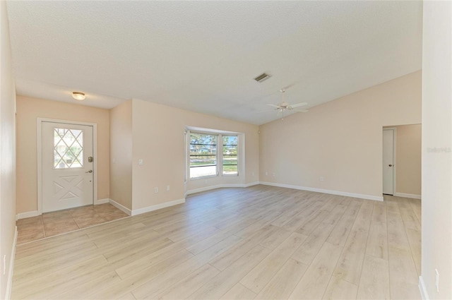 645 Liberty St, Englewood, FL 34223 - foyer featuring light wood-style flooring, healthy amount of natural light, vaulted ceiling, and ceiling fan