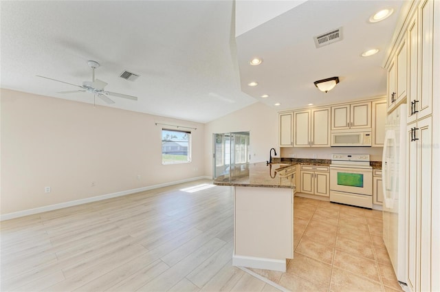 645 Liberty St, Englewood, FL 34223 - kitchen with white appliances, cream cabinetry, a peninsula, open floor plan, and recessed lighting