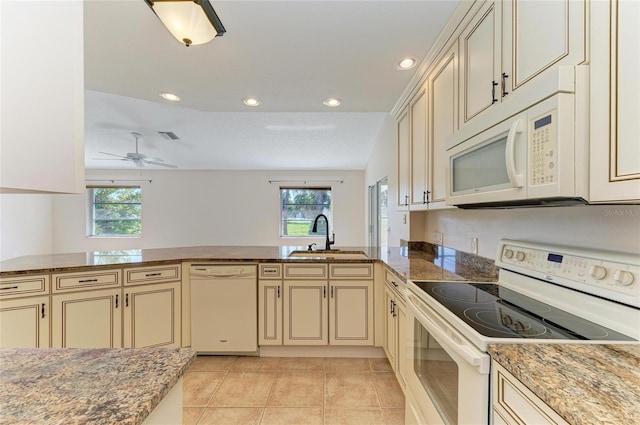 645 Liberty St, Englewood, FL 34223 - kitchen with white appliances, cream cabinetry, a sink, plenty of natural light, and recessed lighting