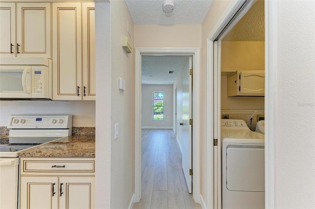 645 Liberty St, Englewood, FL 34223 - laundry room featuring a textured ceiling, baseboards, light wood-type flooring, and washer and dryer