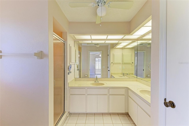 645 Liberty St, Englewood, FL 34223 - full bathroom featuring a shower stall, double vanity, tile patterned floors, and ceiling fan