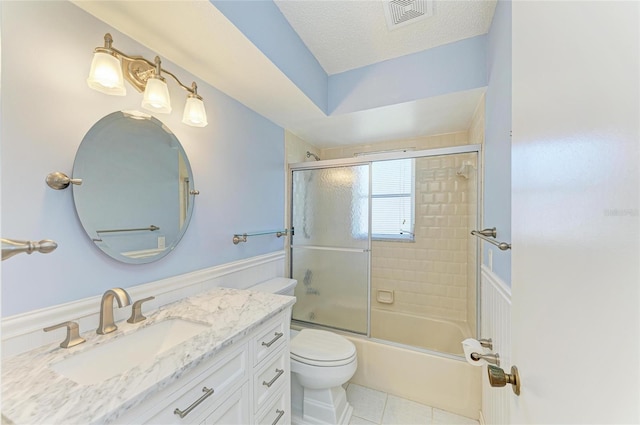 645 Liberty St, Englewood, FL 34223 - bathroom with vanity, toilet, bath / shower combo with glass door, and tile patterned floors