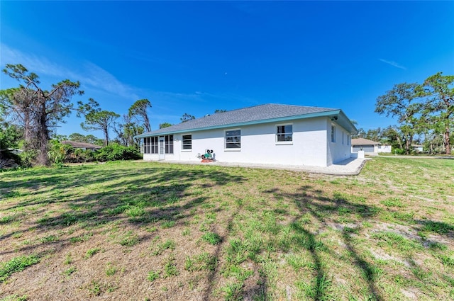 645 Liberty St, Englewood, FL 34223 - back of house featuring a lawn and stucco siding