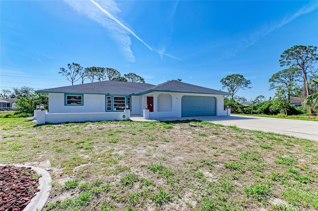 645 Liberty St, Englewood, FL 34223 - single story home with stucco siding, concrete driveway, and an attached garage