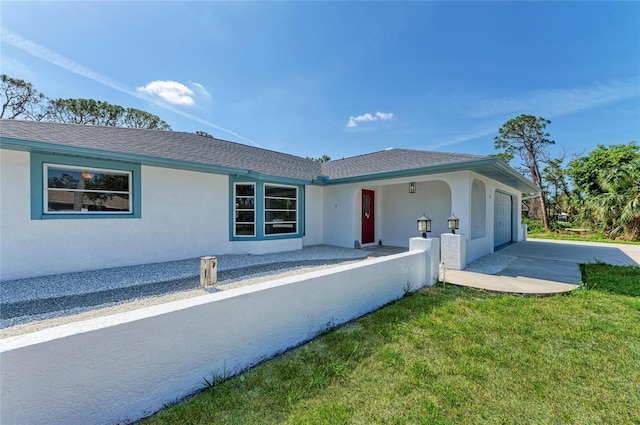 645 Liberty St, Englewood, FL 34223 - ranch-style home featuring stucco siding, an attached garage, driveway, a front lawn, and roof with shingles