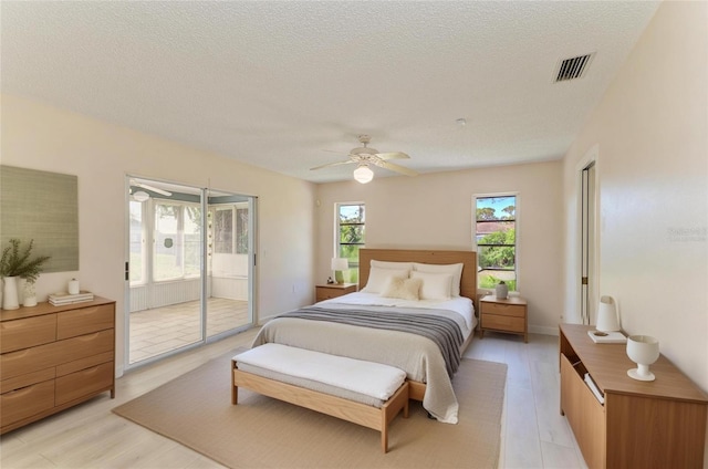 645 Liberty St, Englewood, FL 34223 - bedroom with access to outside, a textured ceiling, ceiling fan, and light wood-style flooring