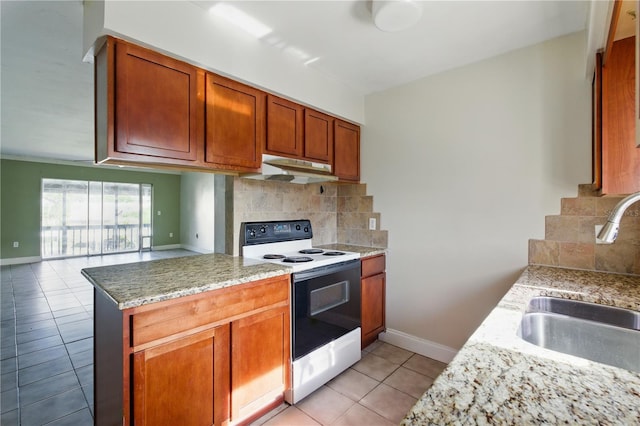 2704 Hidden Lake Blvd Unit C, Sarasota, FL 34237 - kitchen with electric range, under cabinet range hood, light tile patterned flooring, decorative backsplash, and a peninsula