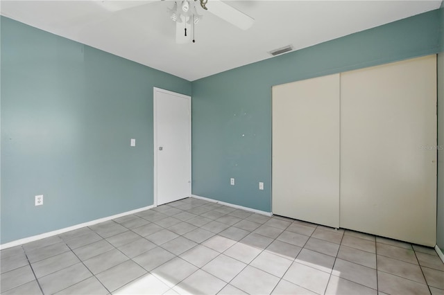 2704 Hidden Lake Blvd Unit C, Sarasota, FL 34237 - unfurnished bedroom featuring light tile patterned flooring, ceiling fan, and a closet