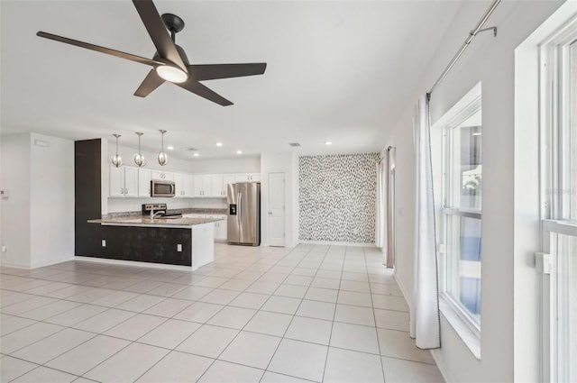 4503 Lindever Ln, Palmetto, FL 34221 - kitchen with appliances with stainless steel finishes, a ceiling fan, light tile patterned flooring, white cabinets, and recessed lighting