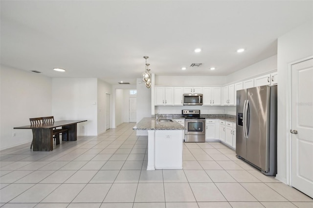 4503 Lindever Ln, Palmetto, FL 34221 - kitchen with appliances with stainless steel finishes, a sink, recessed lighting, white cabinets, and dark stone countertops