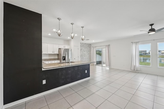 4503 Lindever Ln, Palmetto, FL 34221 - kitchen with stainless steel fridge, recessed lighting, white cabinetry, a peninsula, and open floor plan