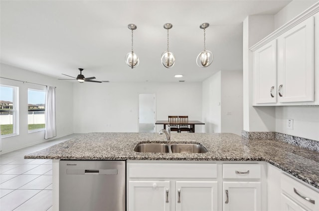 4503 Lindever Ln, Palmetto, FL 34221 - kitchen featuring stainless steel dishwasher, a sink, white cabinets, and a peninsula