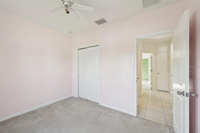 4503 Lindever Ln, Palmetto, FL 34221 - unfurnished bedroom with light carpet, a closet, baseboards, and a ceiling fan