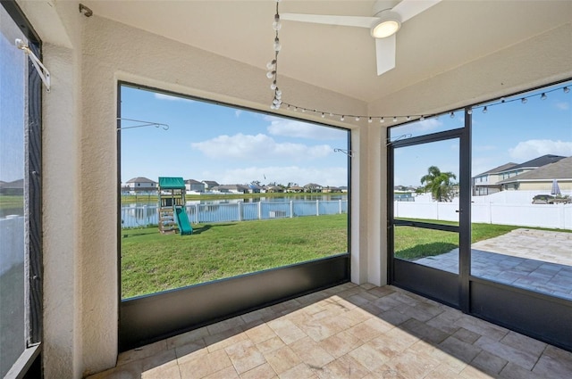4503 Lindever Ln, Palmetto, FL 34221 - unfurnished sunroom featuring a water view, stone finish floors, ceiling fan, a residential view, and lofted ceiling
