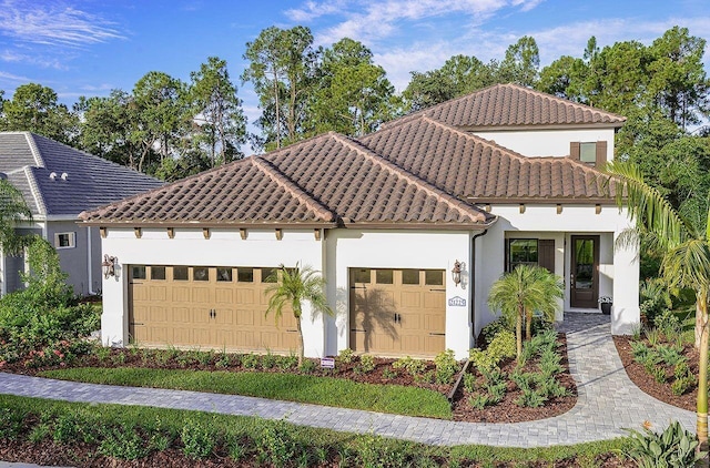 21225 Wacissa Dr, Venice, FL 34293 - mediterranean / spanish home with a garage, stucco siding, and a tiled roof