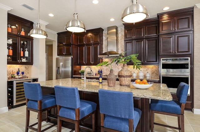 21225 Wacissa Dr, Venice, FL 34293 - kitchen with stainless steel appliances, wall chimney exhaust hood, beverage cooler, backsplash, and a sink