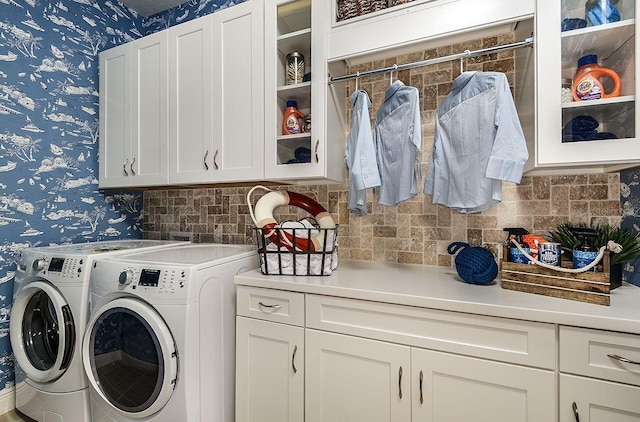 21225 Wacissa Dr, Venice, FL 34293 - laundry room featuring wallpapered walls, cabinet space, and washing machine and clothes dryer