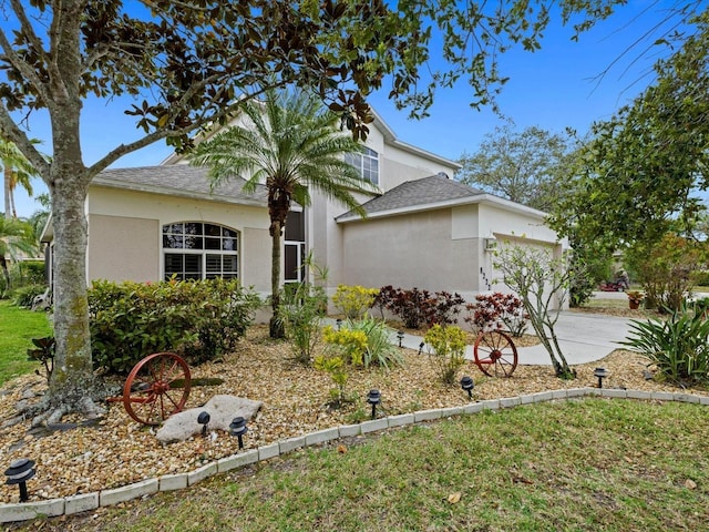 8222 Haven Harbour Way, Bradenton, FL 34212 - view of front of home featuring an attached garage, stucco siding, driveway, and a shingled roof