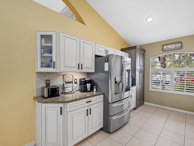 8222 Haven Harbour Way, Bradenton, FL 34212 - kitchen with lofted ceiling, baseboards, light tile patterned floors, glass insert cabinets, and stainless steel fridge with ice dispenser