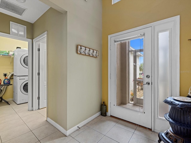 8222 Haven Harbour Way, Bradenton, FL 34212 - foyer with estacked washer and dryer, light tile patterned floors, and baseboards