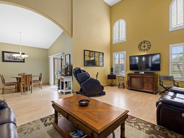8222 Haven Harbour Way, Bradenton, FL 34212 - living area with high vaulted ceiling, arched walkways, wood finished floors, and a chandelier