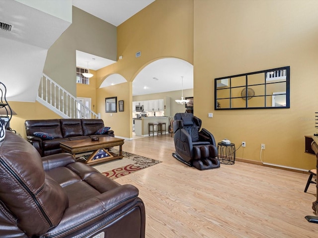 8222 Haven Harbour Way, Bradenton, FL 34212 - living area with a high ceiling, arched walkways, wood finished floors, stairs, and baseboards