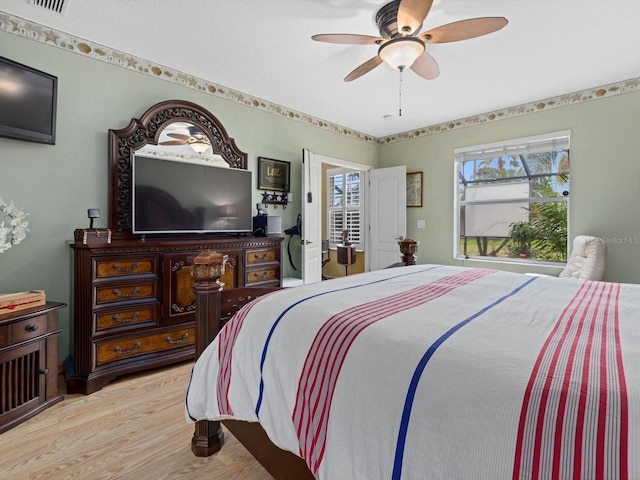 8222 Haven Harbour Way, Bradenton, FL 34212 - bedroom featuring light wood-type flooring, multiple windows, and a ceiling fan