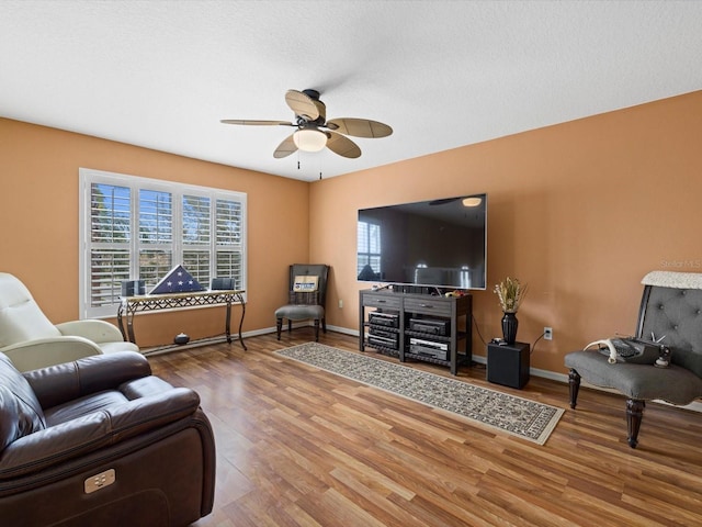8222 Haven Harbour Way, Bradenton, FL 34212 - living room with ceiling fan, healthy amount of natural light, wood finished floors, and baseboards
