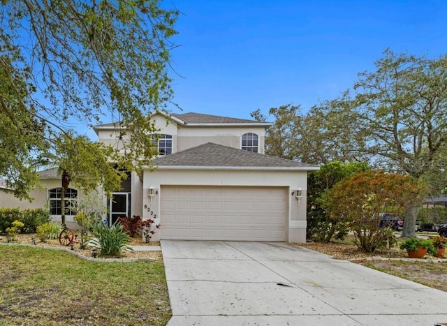 8222 Haven Harbour Way, Bradenton, FL 34212 - traditional-style house with stucco siding, an attached garage, driveway, and roof with shingles