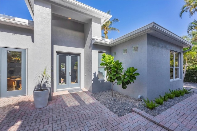 4505 Camino Real, Sarasota, FL 34231 - view of exterior entry featuring stucco siding and french doors
