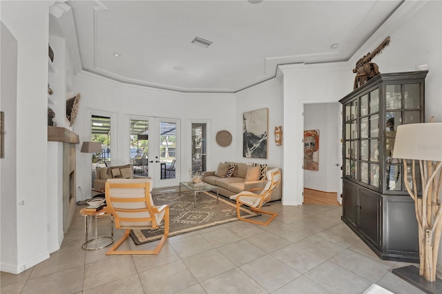 4505 Camino Real, Sarasota, FL 34231 - living area with french doors, a fireplace, light tile patterned floors, baseboards, and ornamental molding